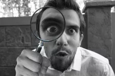 Man with magnifying glass. Photo: Pixabay.